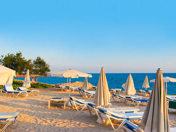 Beach chairs and sunshades on mediterranean sand beach. taken with lensbaby lens