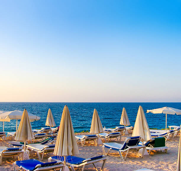 istock Beautiful sunny lounges near the pool 462653937