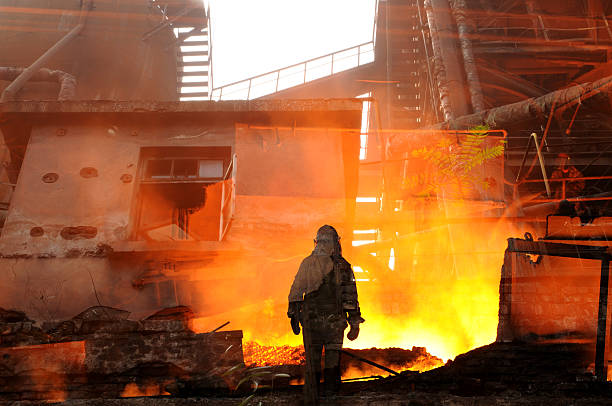 istock Lone fireman standing in front of burning building 462674573