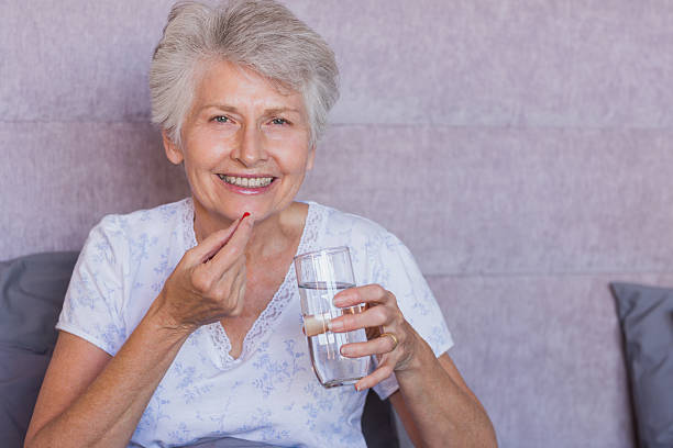 istock Retired woman taking medication in her bed 462674767