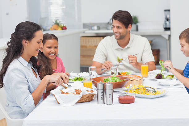 istock Cheerful family eating lettuce and pizza 462675763