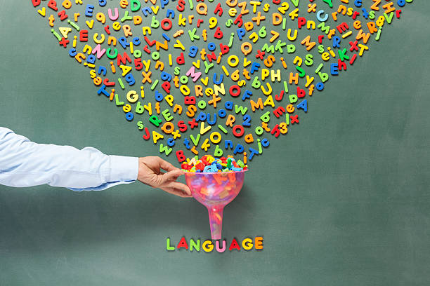 istock Stack of letters in chaos turning into language on blackboard 462676195