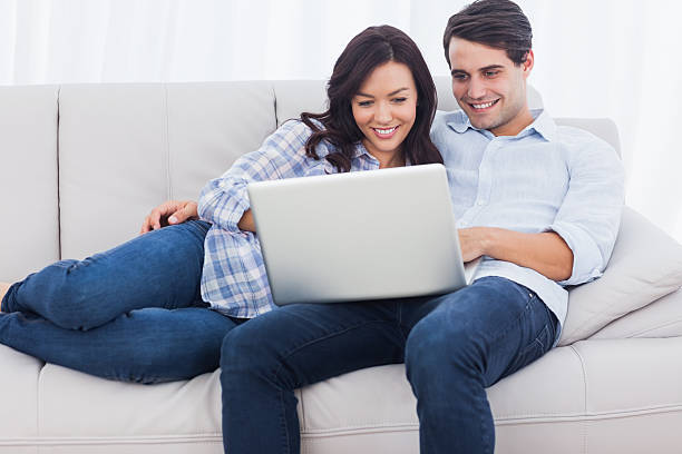 istock Woman leaning on her boyfriend and using a laptop 462680445