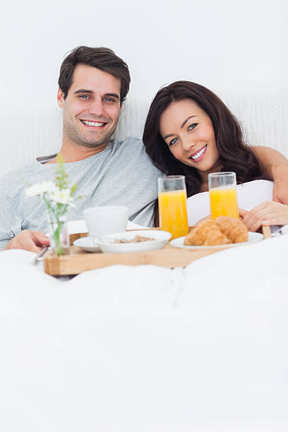 istock Cute couple having breakfast in bed 462680945
