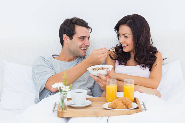 istock Man feeding his wife with cereal during a romantic breakfast 462680981