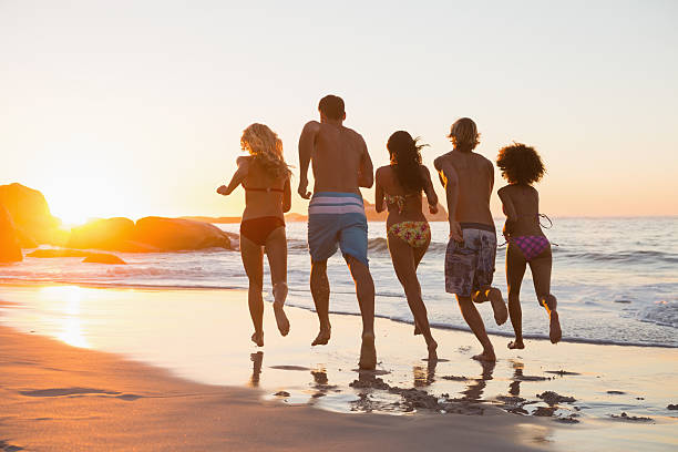 istock Young friends running together as the sun is setting 462681231