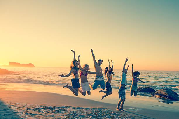 istock Happy friends jumping together on the beach 462681527