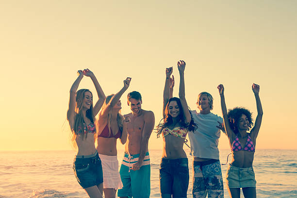 istock Young friends raising arms and having fun 462681543