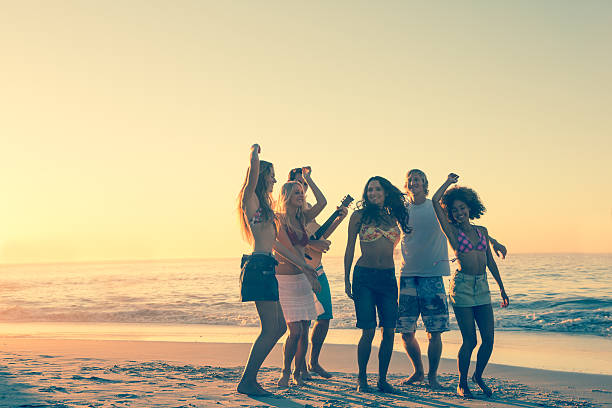 istock Friends having fun and dancing on the beach 462681545