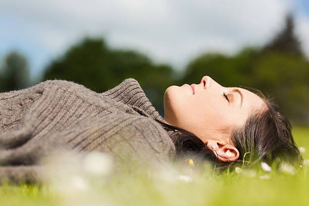 istock Content pretty woman relaxing on the grass 462681611