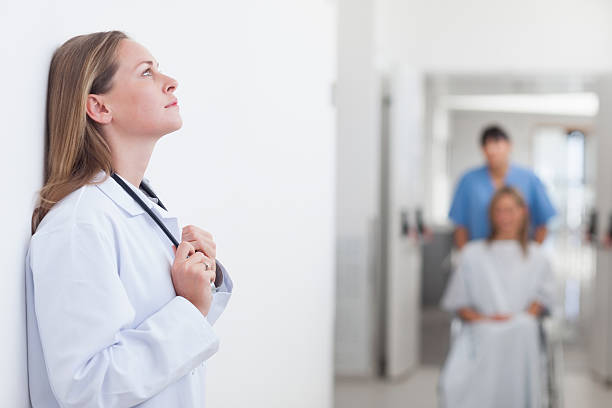 istock Thoughtful doctor leaned against a wall in hospital 462710667