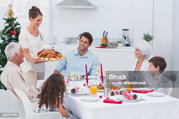 Woman Bringing Food At A Christmas Dinner Stock Photo - Download Image Now - Carrying, Dinner, Kitchen