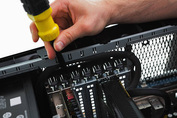 istock Hand holding a screwdriver in front of an open cpu 462712171