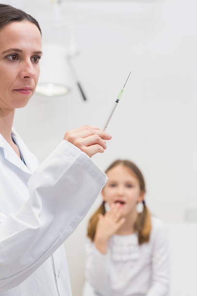 istock Pediatrician holding a syringe 462715857