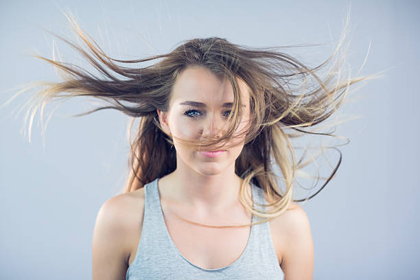 istock Windswept blonde woman in tank top smiling 462716355