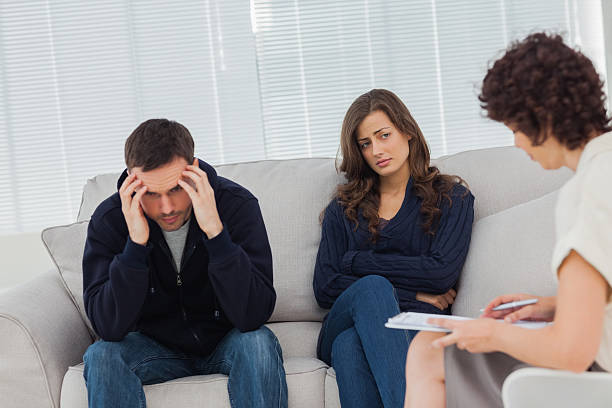 istock Young couple sitting on the couch during therapy session 462716389