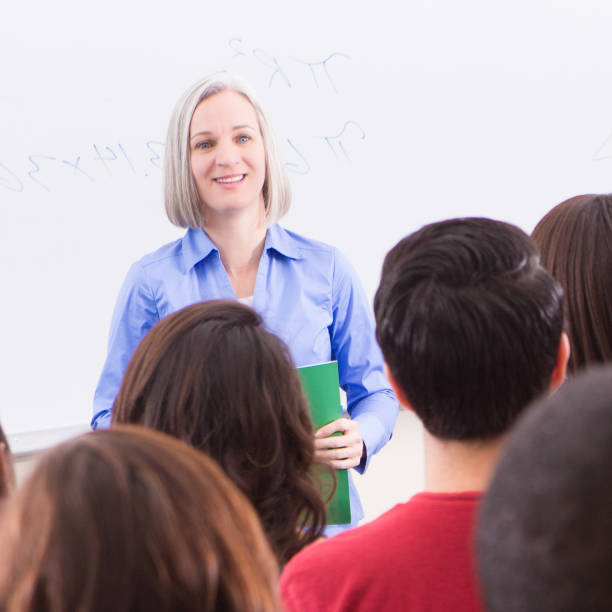 istock Senior professor instructing students in college lecture hall classroom 462716877