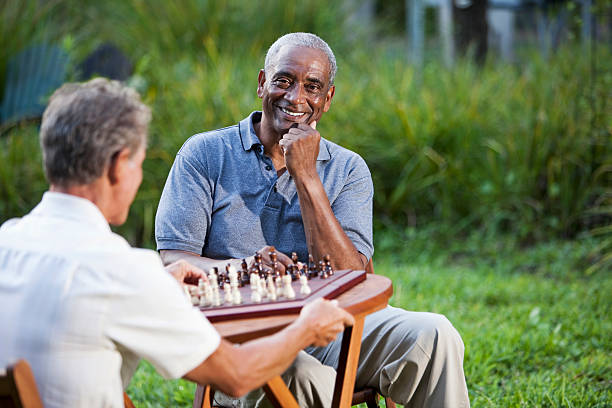 istock Senior men playing chess in park 462716973