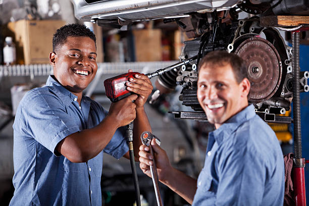 istock Auto mechanics in garage working on car transmission 462719011
