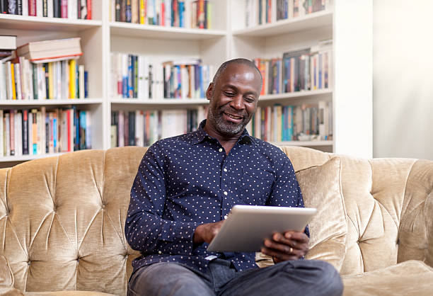 istock Mature african man with digital tablet smiling 462719703