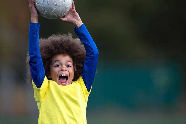 Boy Catching A Football