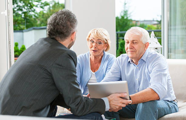 istock Senior couple talking with financial advisor 462720301