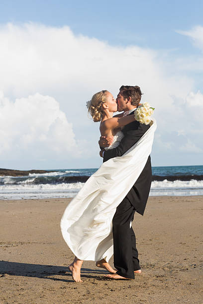istock Happy lovely young newlyweds posing kissing 462720747