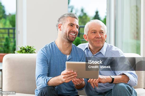 Father And Adult Son With Digital Tablet Stock Photo - Download Image Now - 30-39 Years, 40-49 Years, 60-69 Years