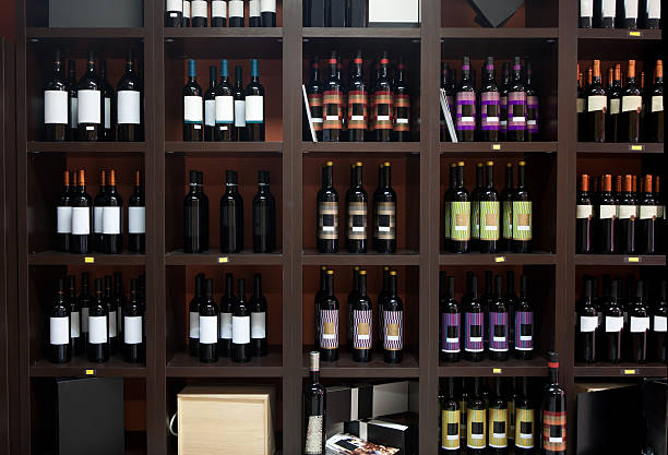 wine shop. - wine bottle store collection alcohol stock-fotos und bilder