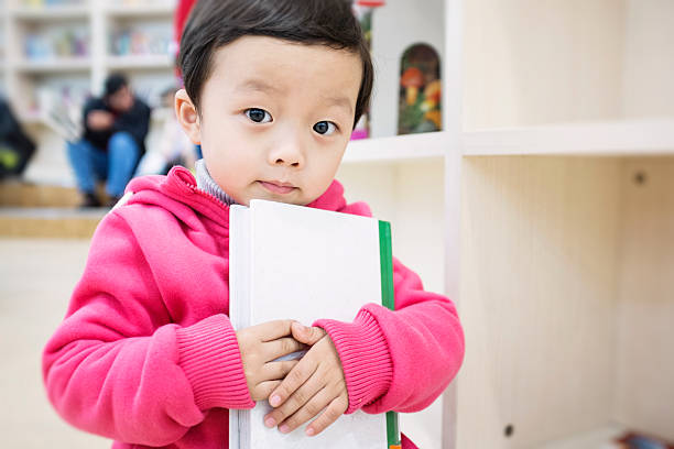 istock Cute asia children in the library 462722111