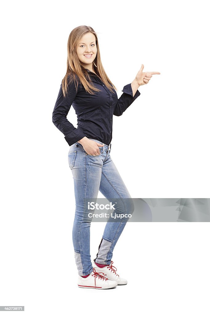 Young casual woman pointing with hand Full length portrait of a young casual woman pointing with hand isolated on white background 20-29 Years Stock Photo