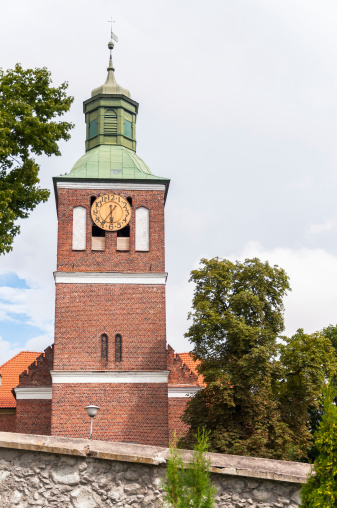 Church tower in Wegorzewo with big wooden clock, Masurian Lakes District, northern Poland