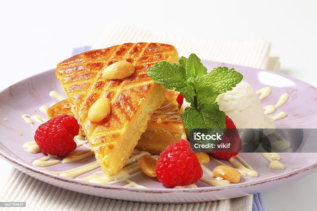 Almond cake with ice cream and raspberries Almond cake with ice cream and fresh raspberries Almond Stock Photo
