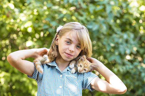 istock Girl play with kitten 462761055