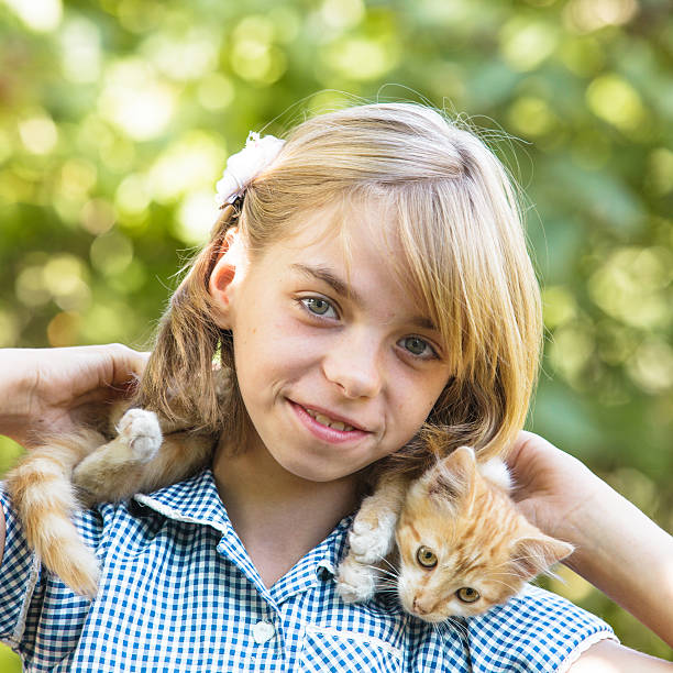 istock Girl play with kitten 462761097