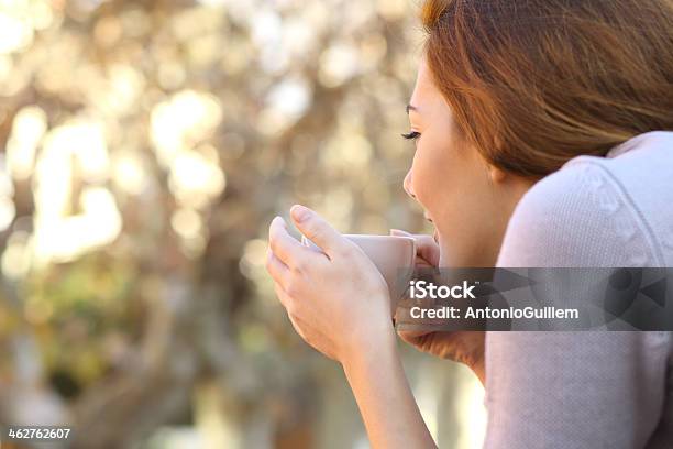 Relaxed Woman Holding A Cup Of Coffee Outdoor Stock Photo - Download Image Now - Coffee Cup, Rear View, Teenage Girls