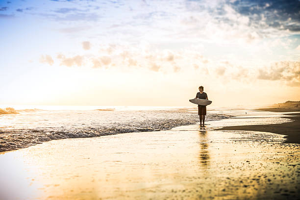 istock Skim boarder at sunset on a beach 462764539