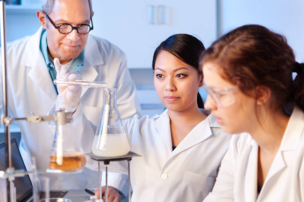istock Science Teacher with Students in Chemistry Laboratory Horizontal 462764575