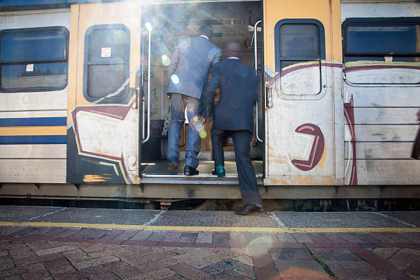 African businessmen getting into the train. Cape Town, South Africa.