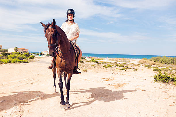 istock young woman horseback riding 462770501