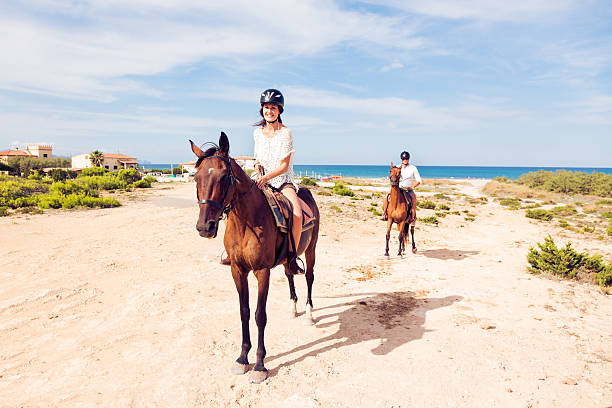 young tourist couple horseback riding