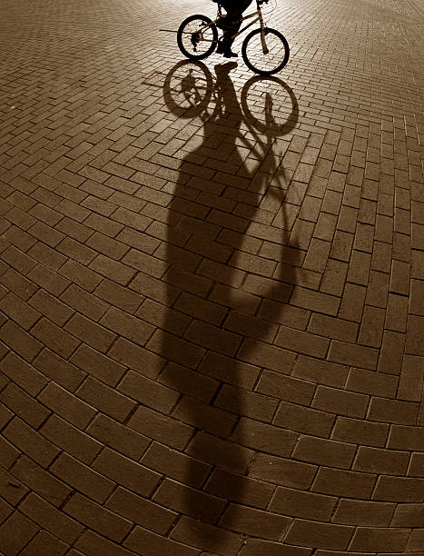 istock Shadow of bicycler on cobblestones 462771683