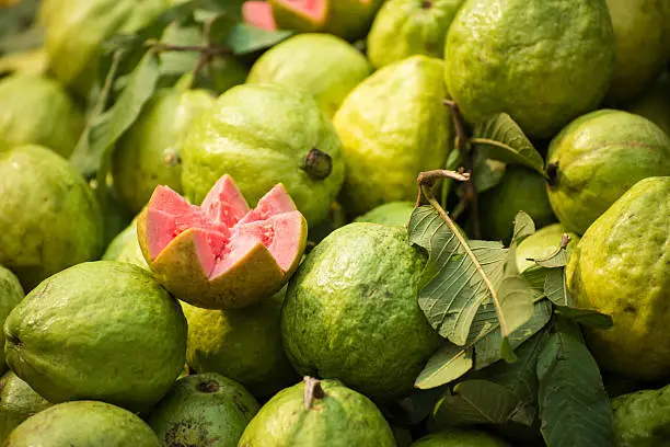 Cut, ready to eat, ripe guava displayed by an outdoor street vendor in New Delhi, India.