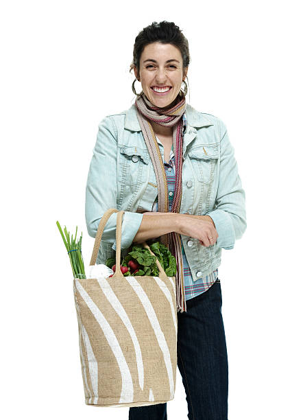 istock Cheerful woman standing with vegetables bag 462776383