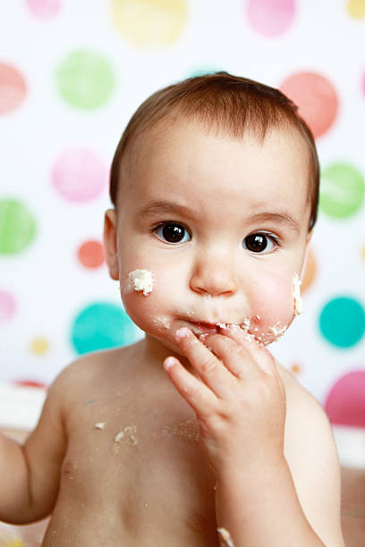istock Baby Boy with Birthday Cake on His Face 462776761