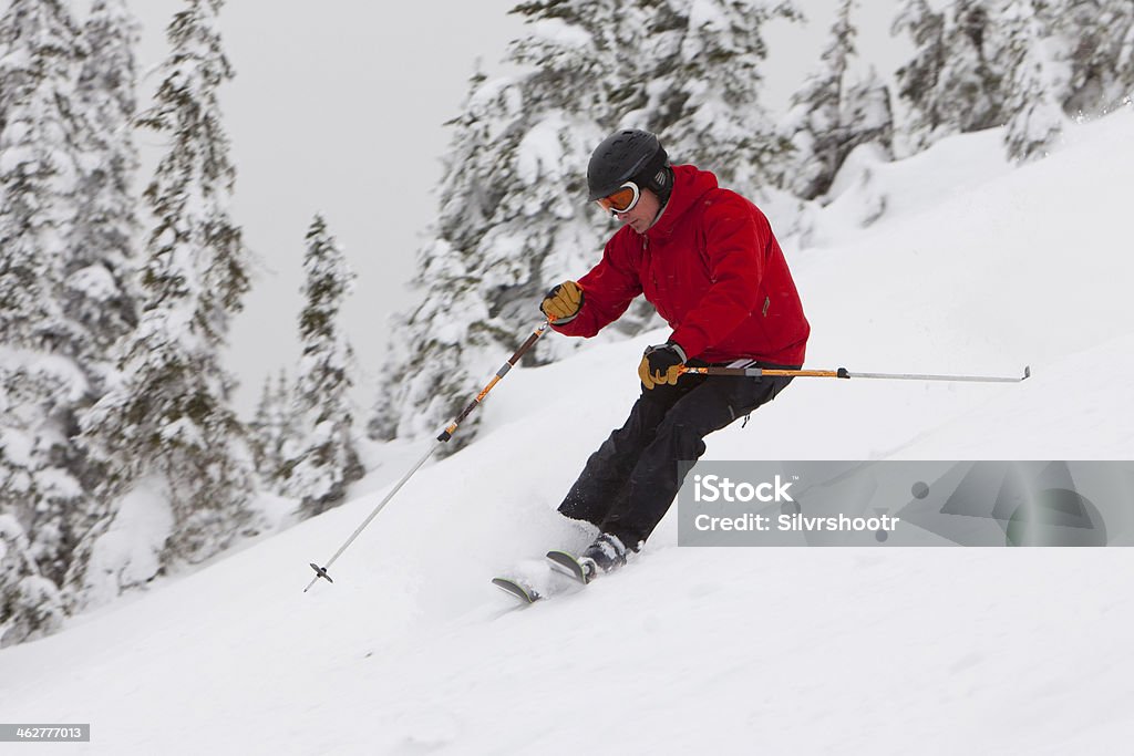 Skier at speed on a downhill run. A male skier is turning as he descends a slope at a ski resort. Idaho Stock Photo