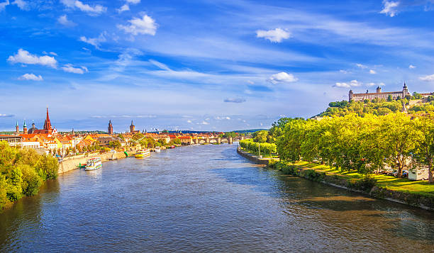 Würzburg Cityview over the river Main Elevated view over the river Main and sightseeing boatson the skyline of Würzburg with its churches, historic Old Mian Bridge and the Feste Marienberg in the distance franconia photos stock pictures, royalty-free photos & images