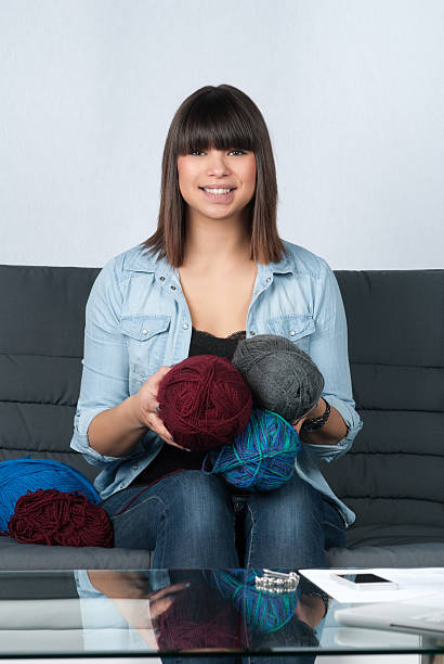istock Young woman holds balls of wool 462779121