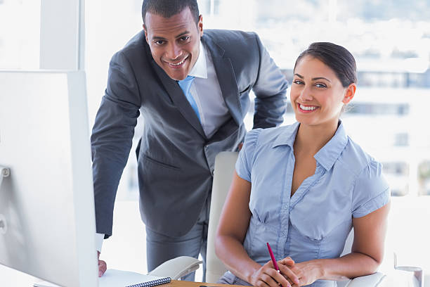 istock Business people in office smiling at camera 462779877