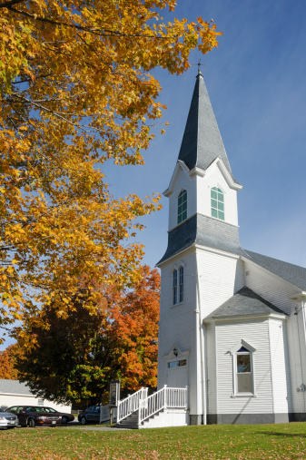 Fall colors in leaves, deep blue sky and classic white church make a iconic New England, or thanksgiving image. Taken in Lagrange, Maine, in early October.